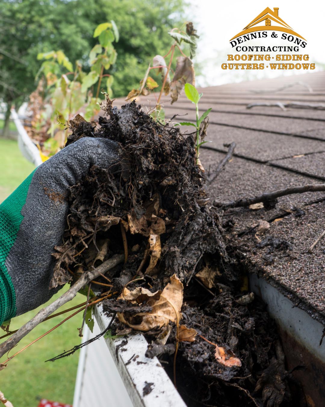 A worker cleaning gutters on a Maryland home, using a ladder and tools to remove debris and ensure proper drainage.